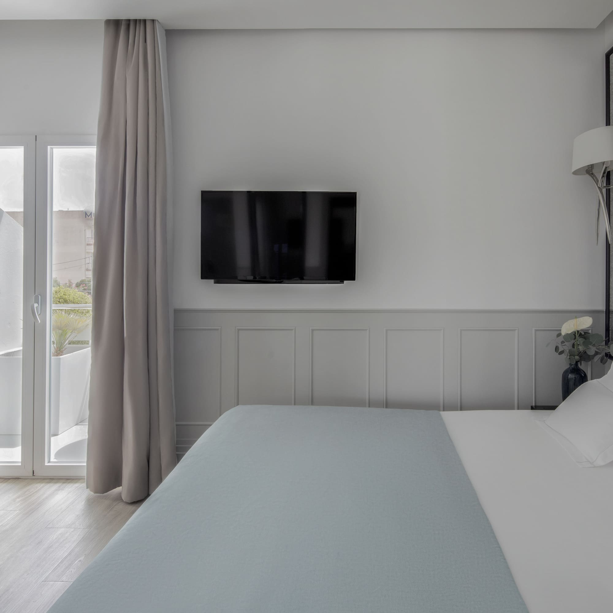 a bed with a flat screen tv in a room