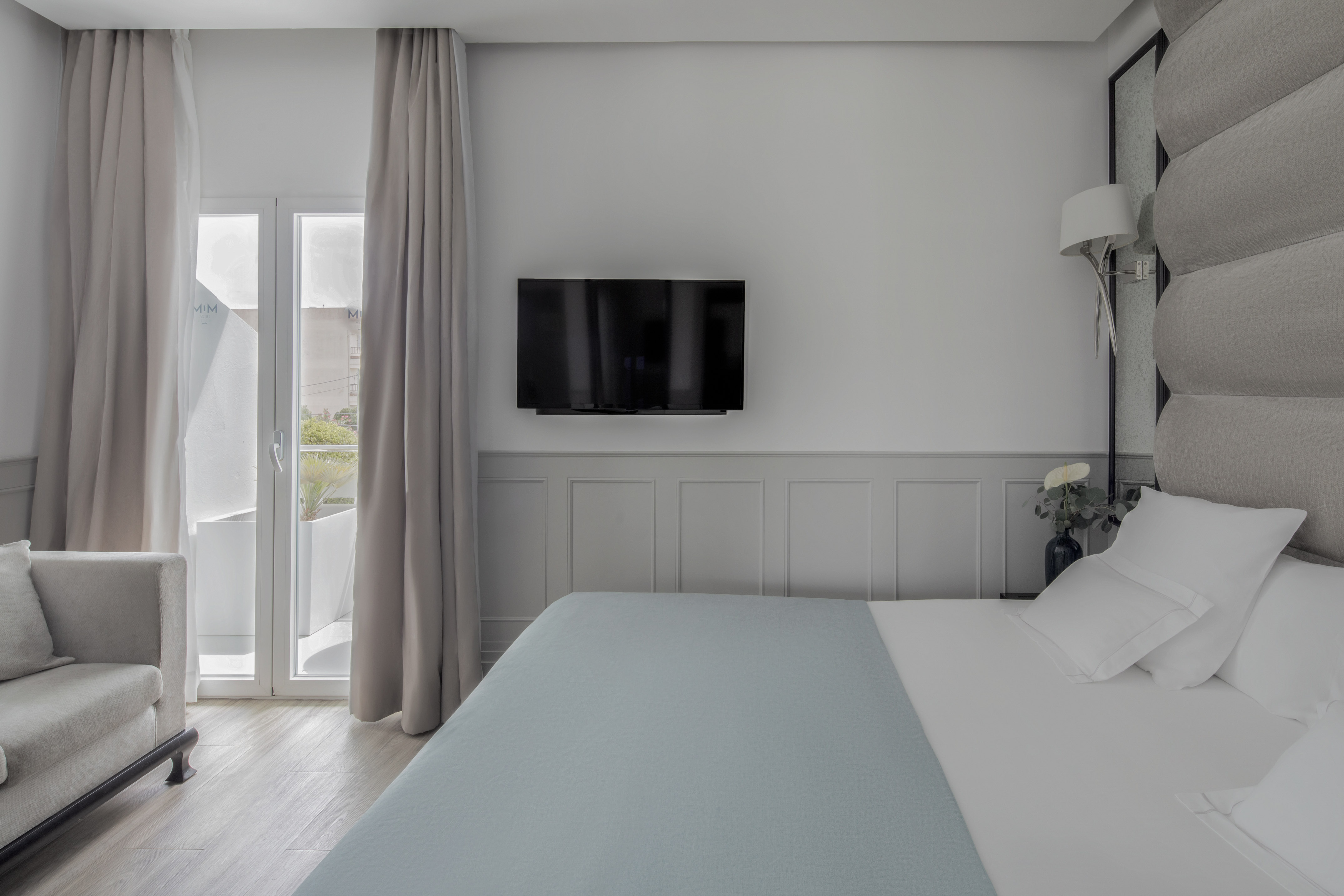 a bed with a flat screen tv in a room