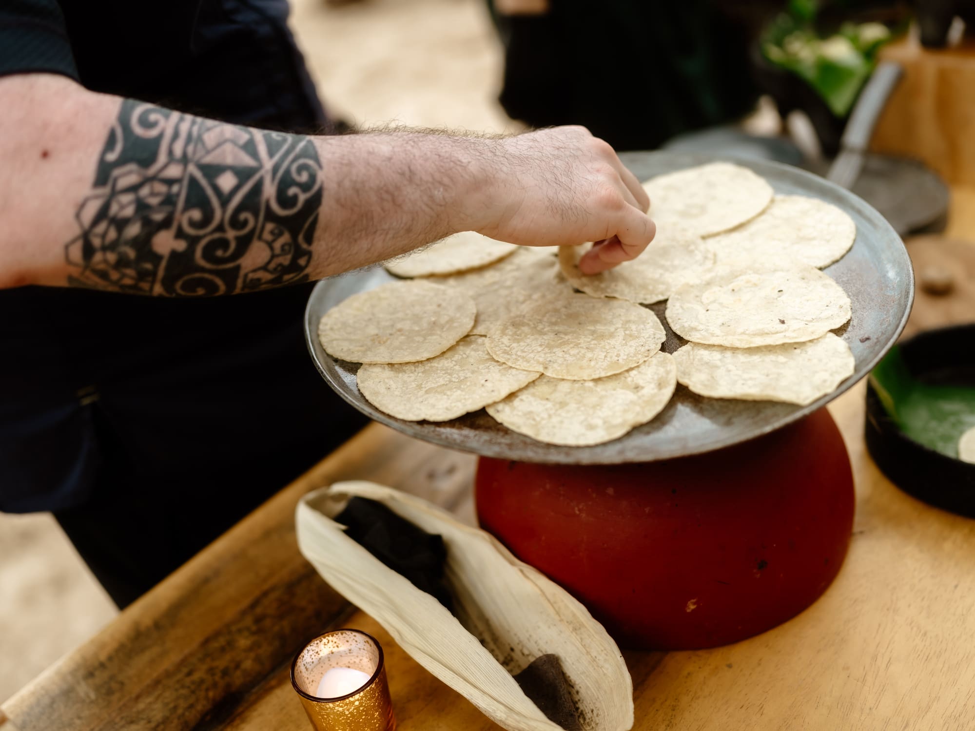 a person putting tortillas on a plate