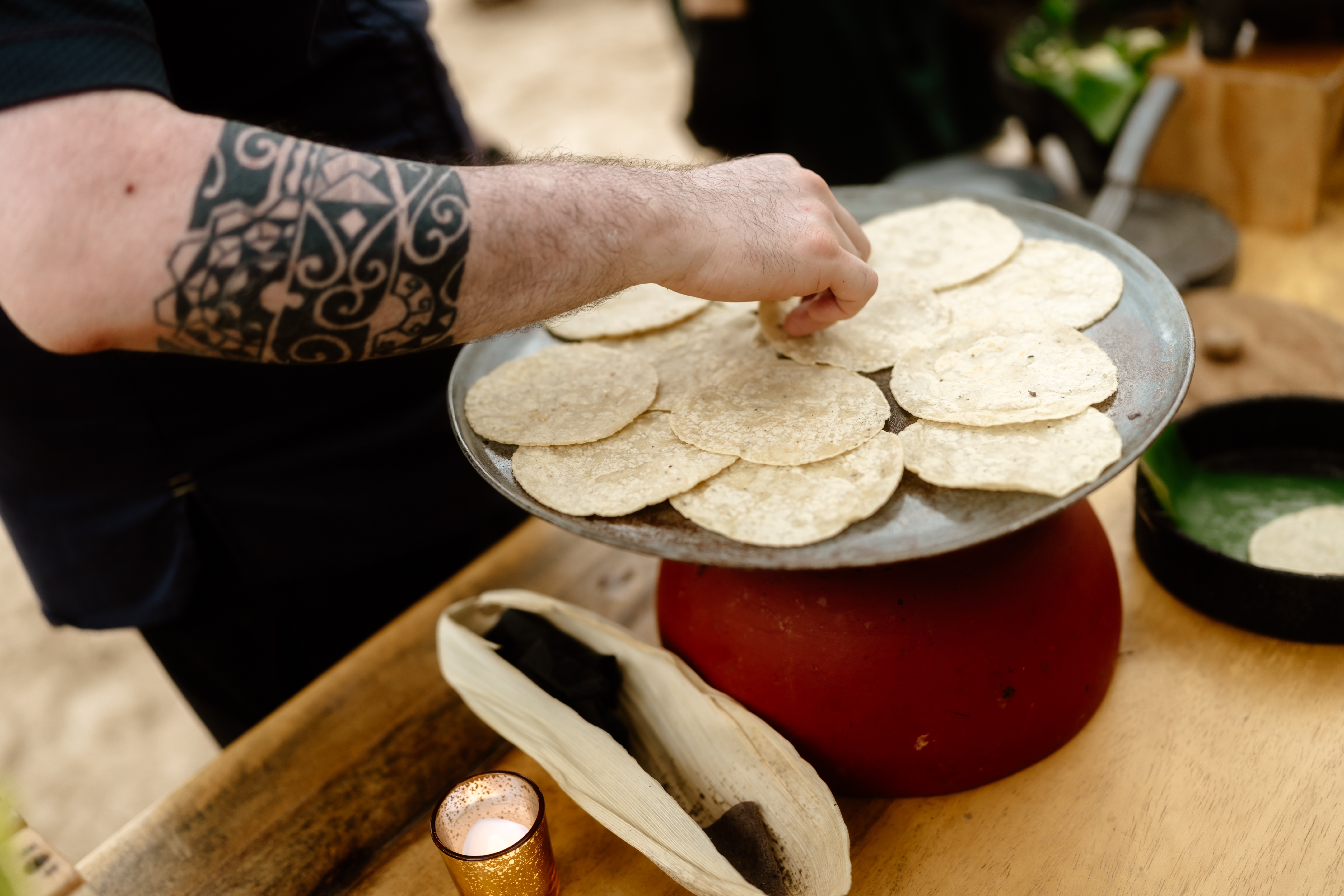 a person putting tortillas on a plate
