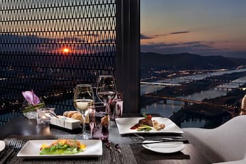 a table with plates of food and glasses of wine