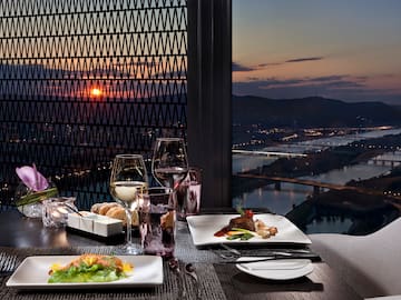 a table with plates of food and glasses of wine