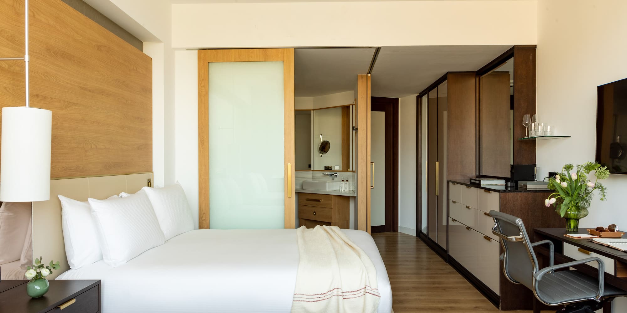 a bedroom with a double bed and a desk