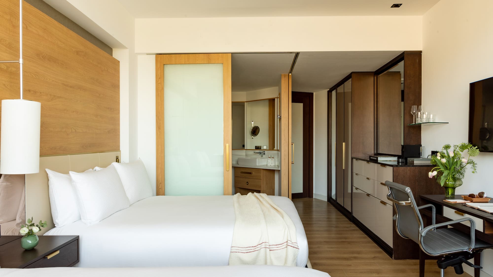 a bedroom with a double bed and a desk