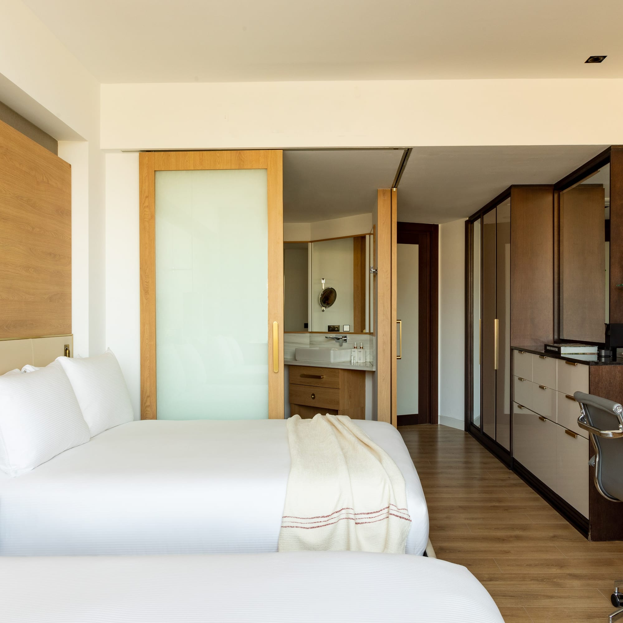 a bedroom with a double bed and a desk