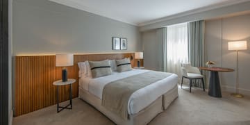 a bedroom with a bed and a table and chairs