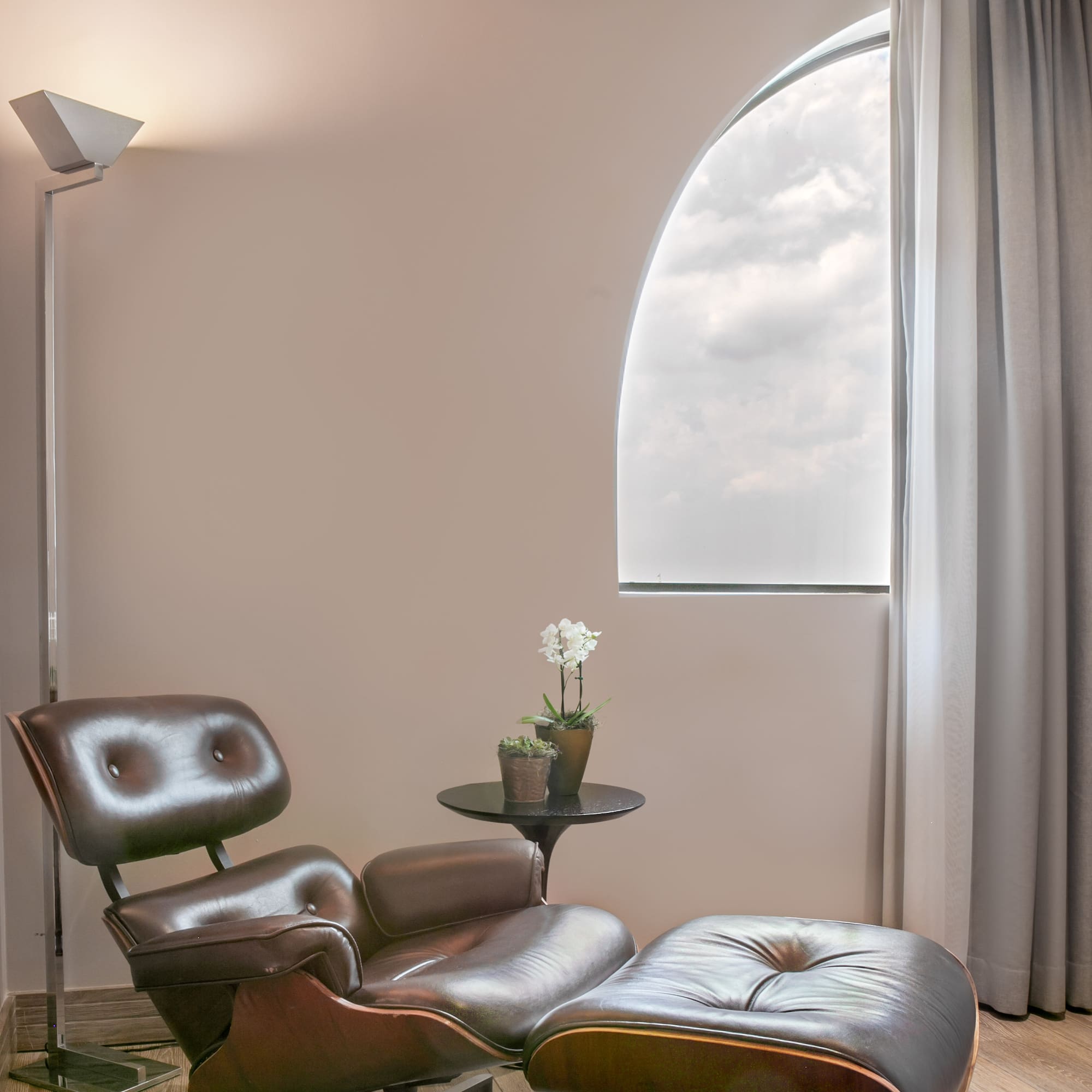 a chair and ottoman in a room