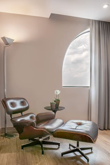 a chair and ottoman in a room