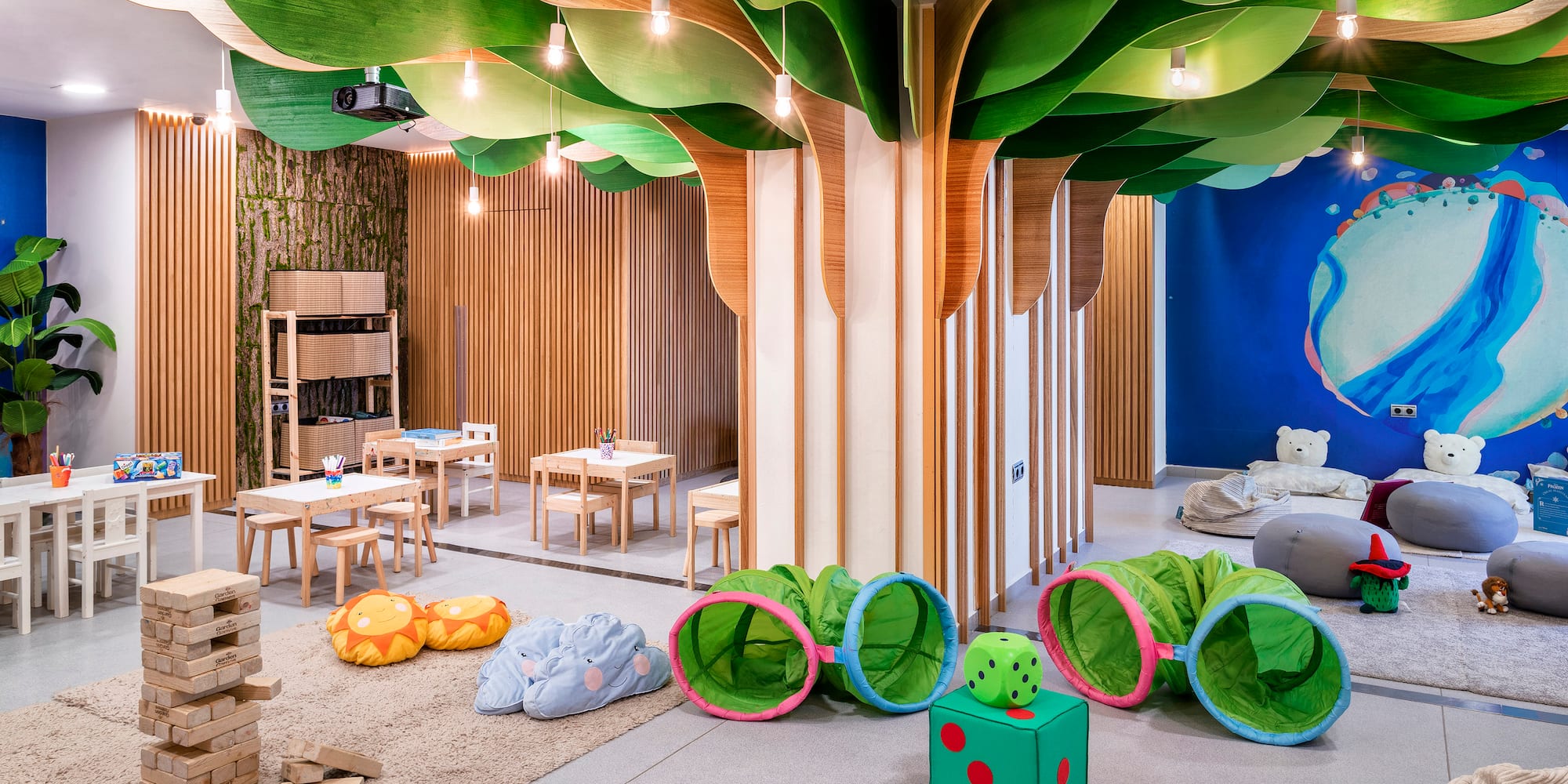 a room with a tree shaped ceiling and a kid's playroom