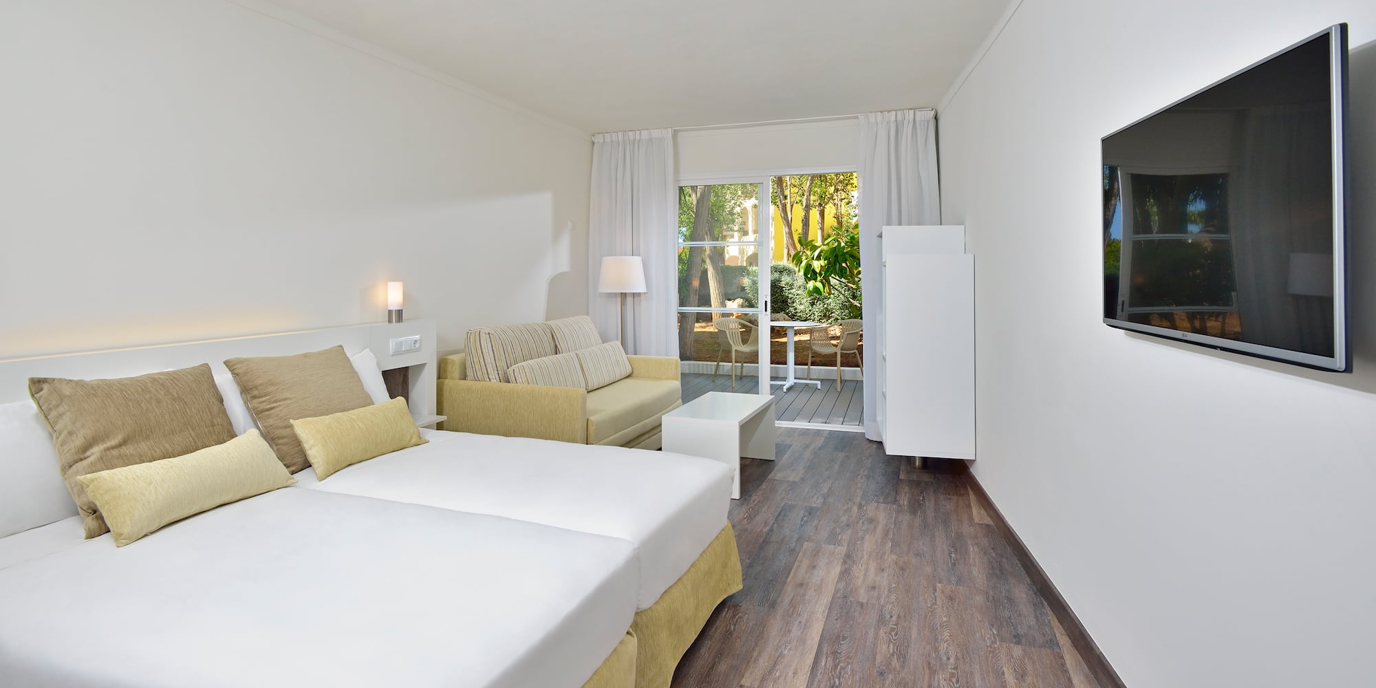 a room with two beds and a couch