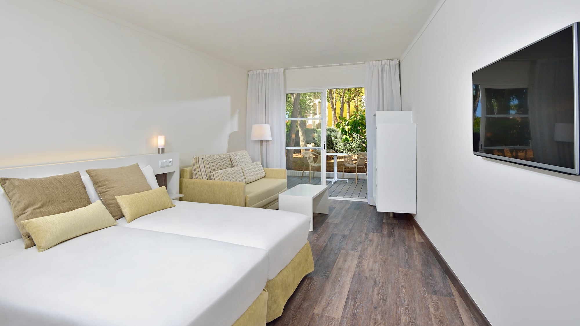 a room with two beds and a couch