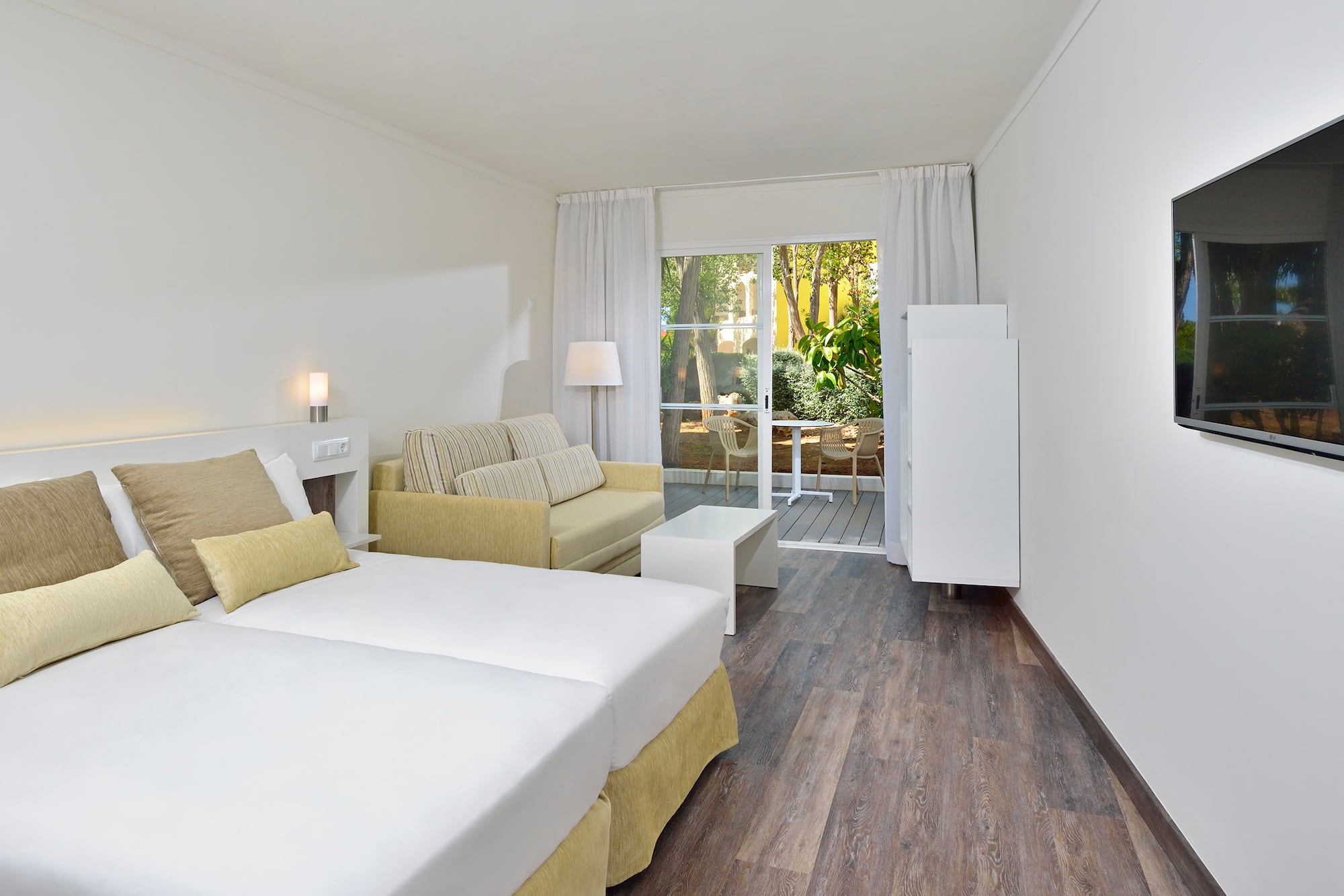 a room with two beds and a couch