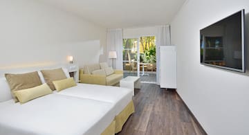 a room with two beds and a couch