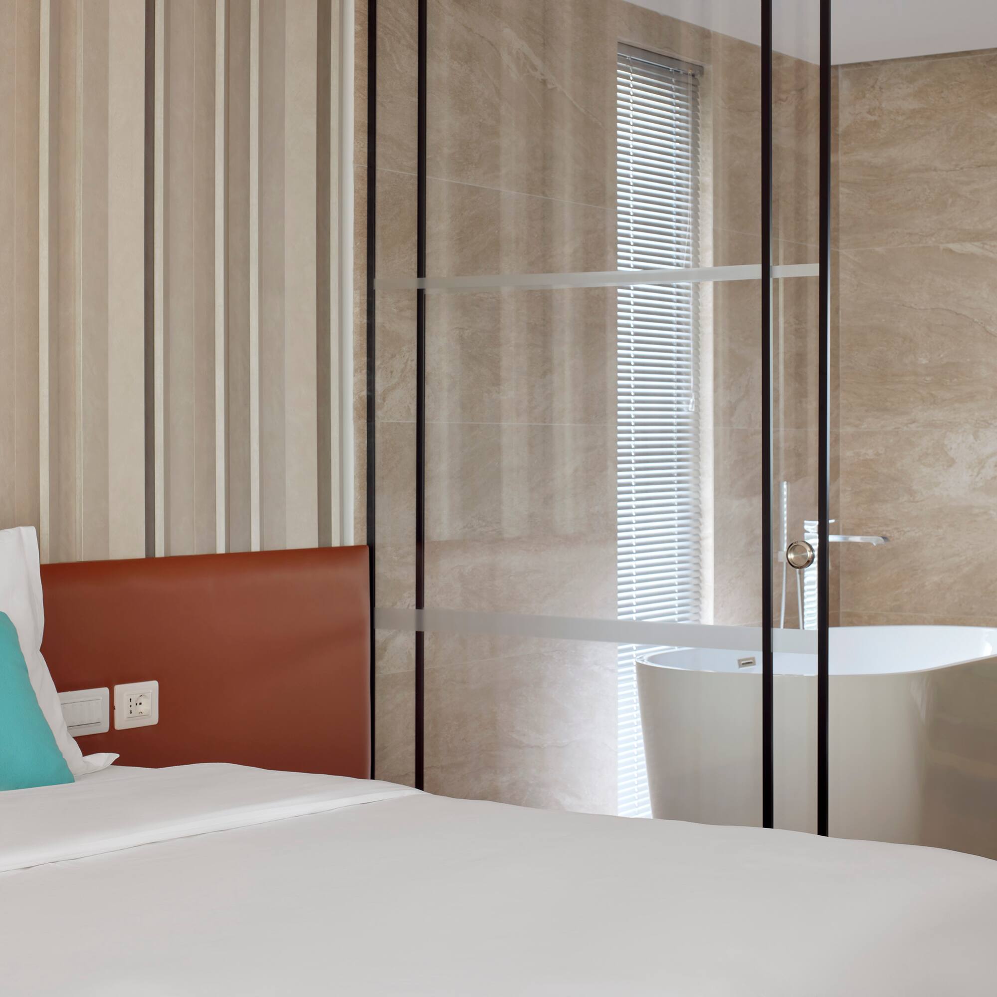 a bed with a bathtub in a room