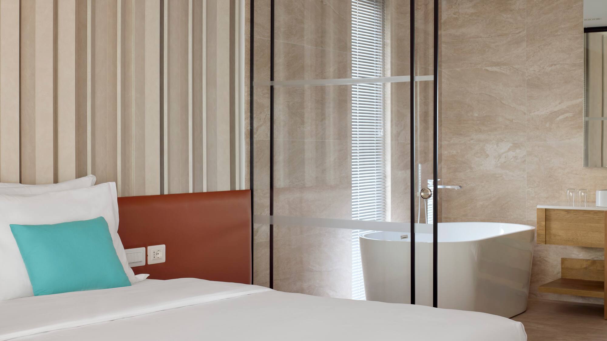 a bed with a bathtub in a room