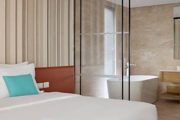 a bed with a bathtub in a room