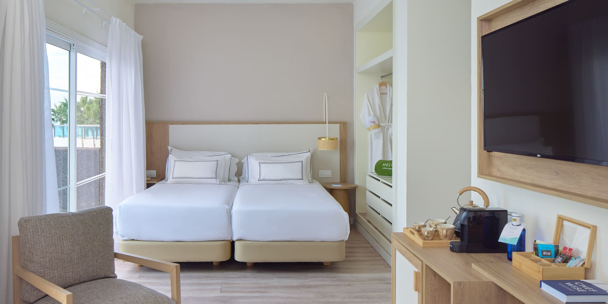 a room with two beds and a tv