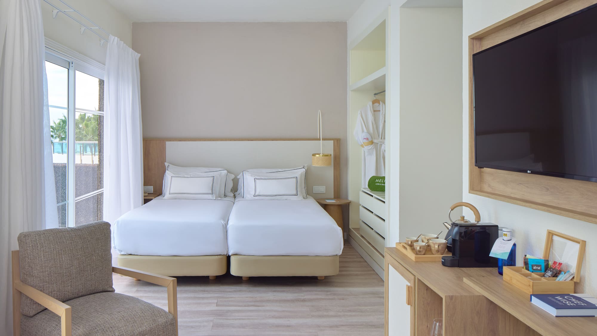 a room with two beds and a tv