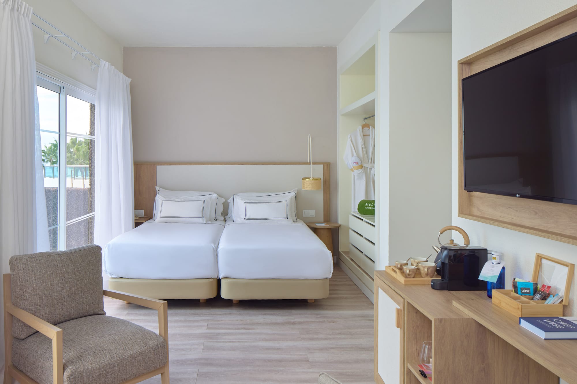 a room with two beds and a tv