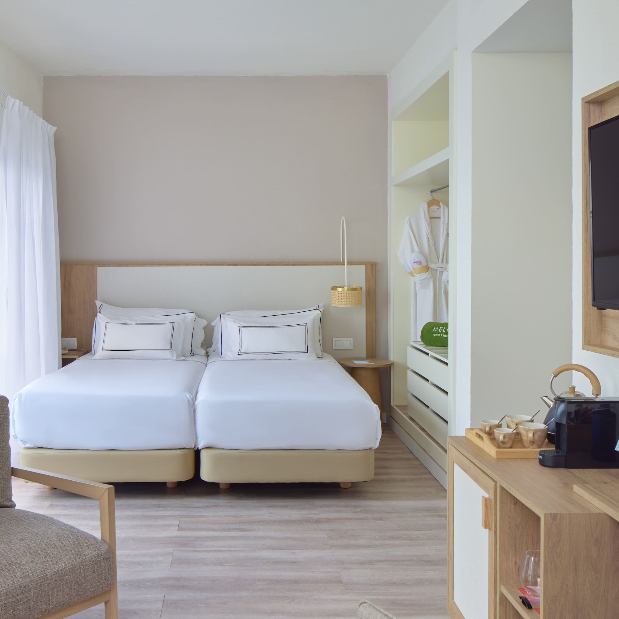 a room with two beds and a tv