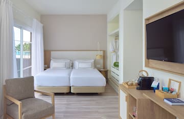 a room with two beds and a tv