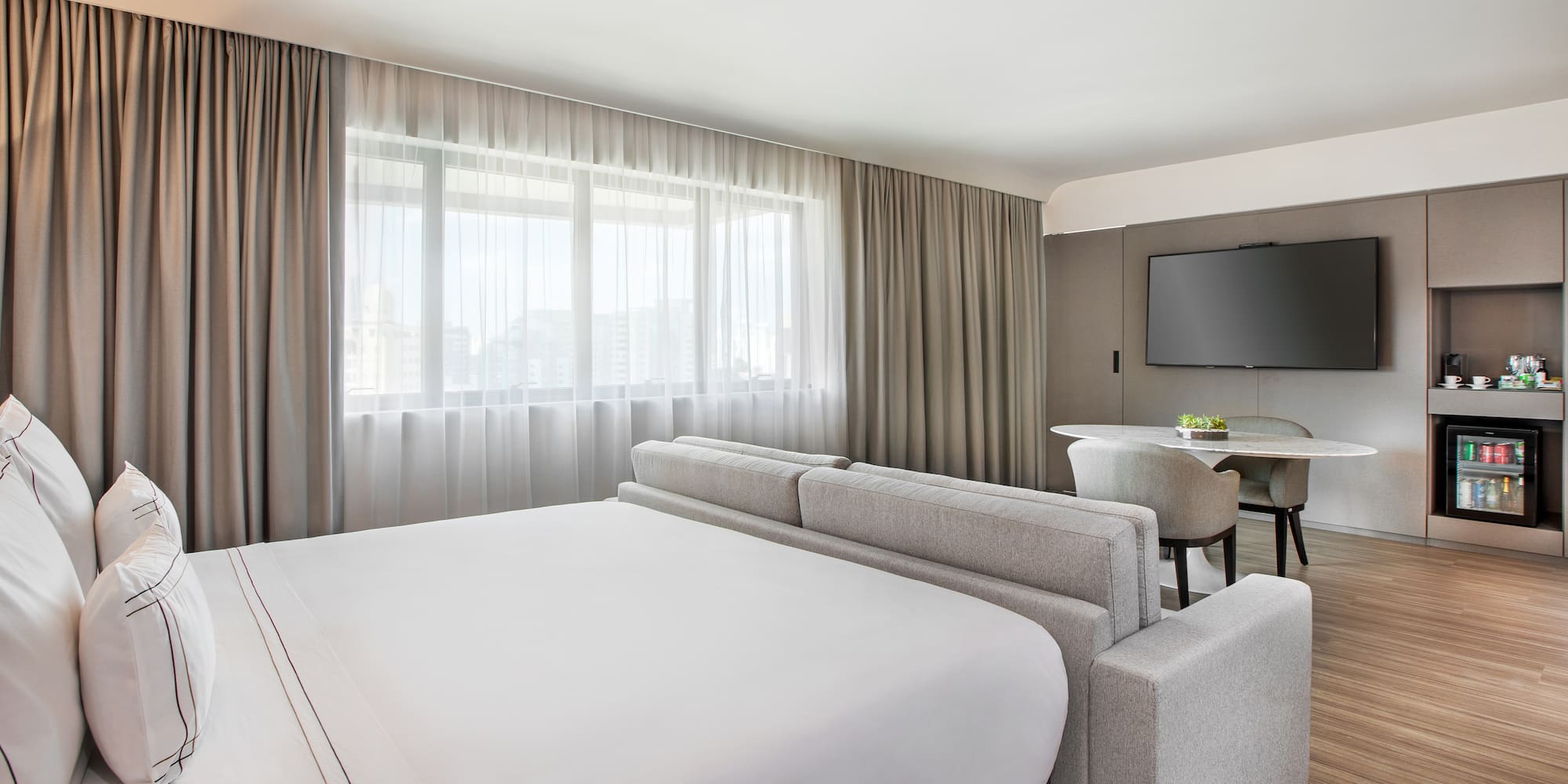 a room with a bed and a television