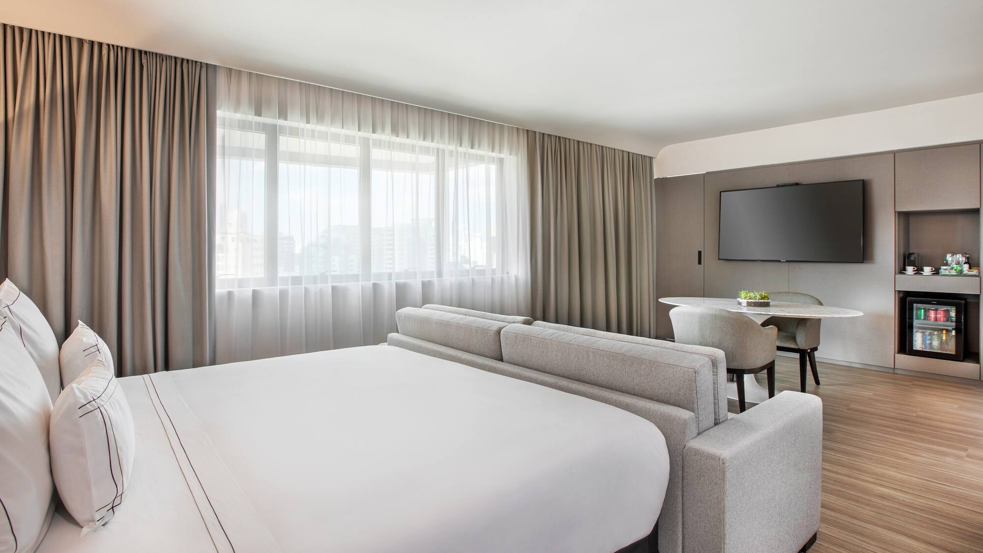 a room with a bed and a television