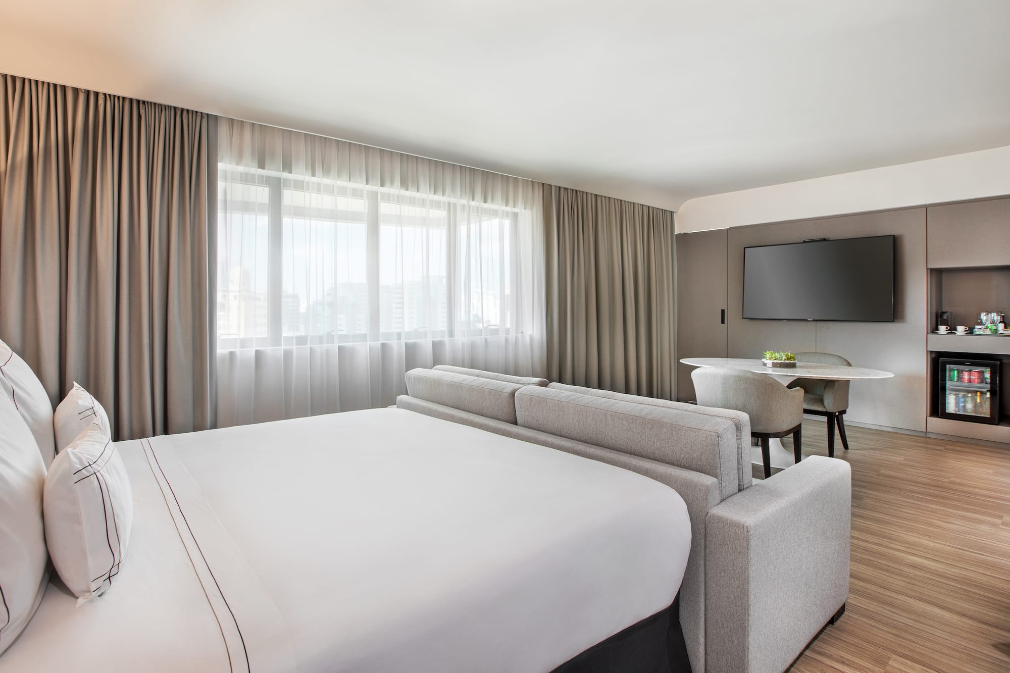 a room with a bed and a television