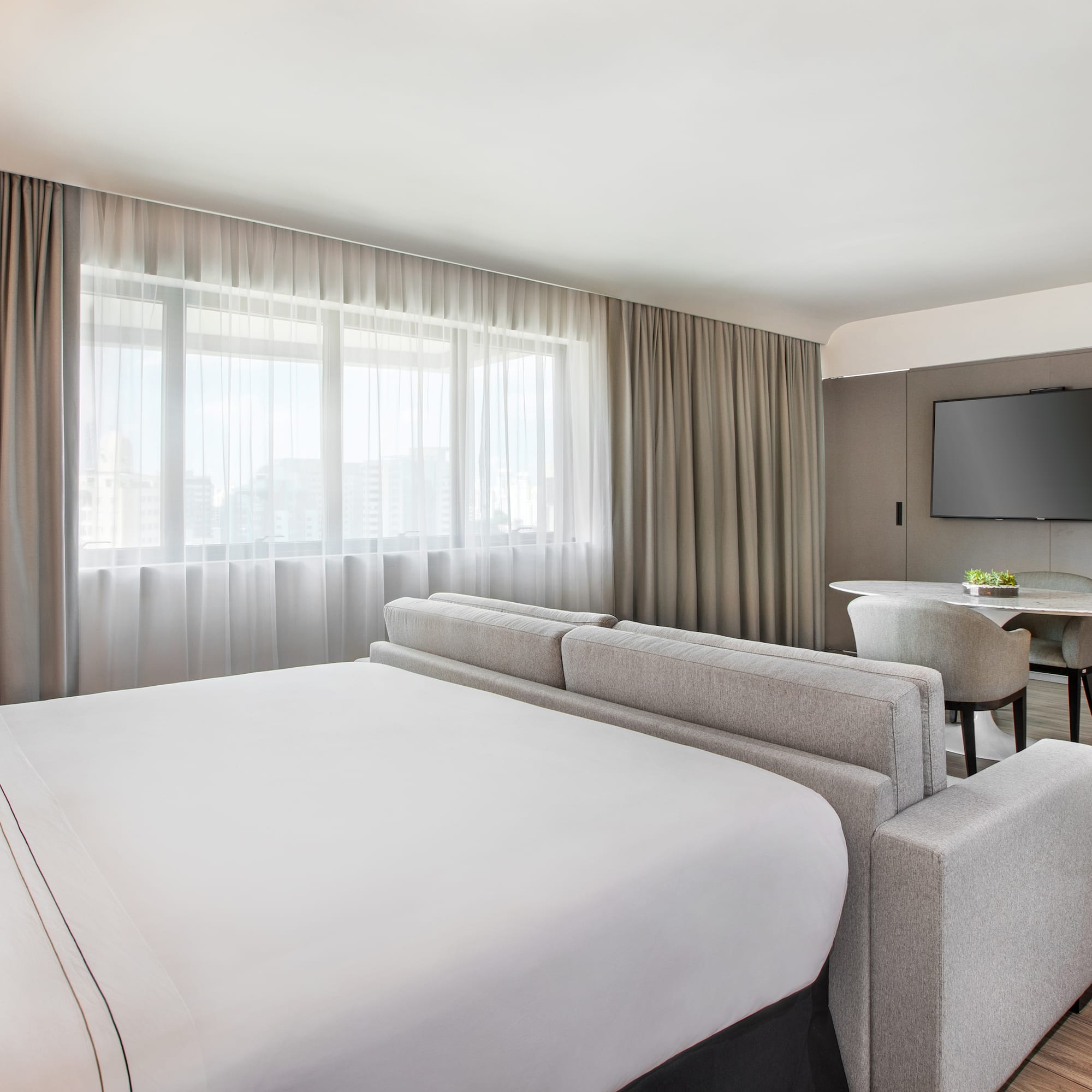 a room with a bed and a television