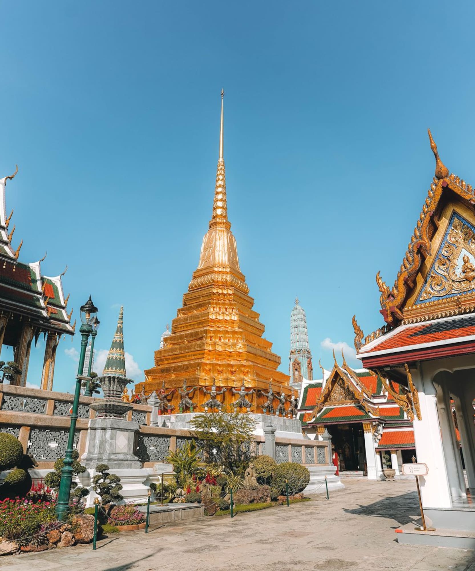 Golden pagoda and ornate Thai temple architecture at Wat Phra Kaeo, Bangkok.
