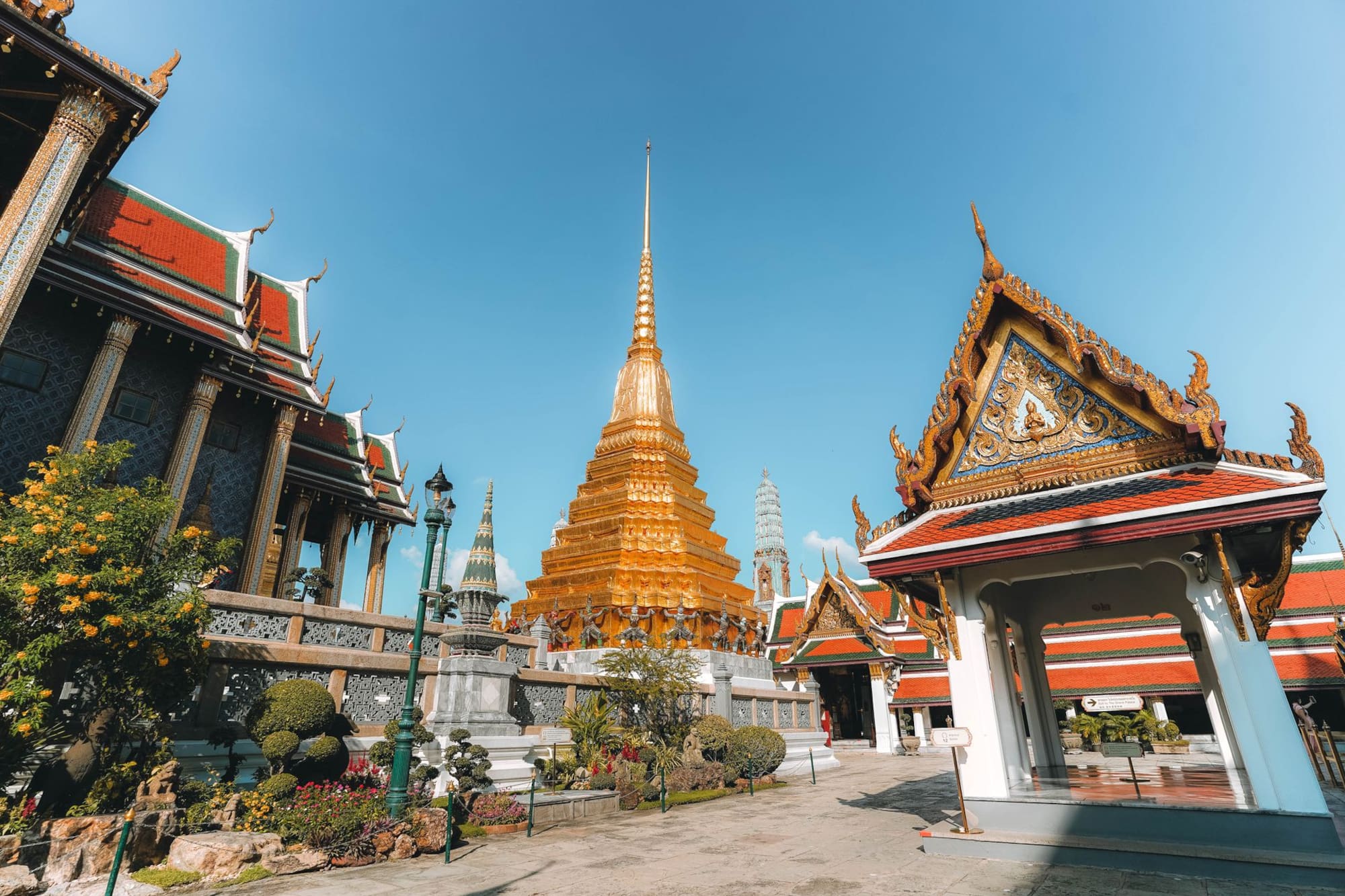 Golden pagoda and ornate Thai temple architecture at Wat Phra Kaeo, Bangkok.