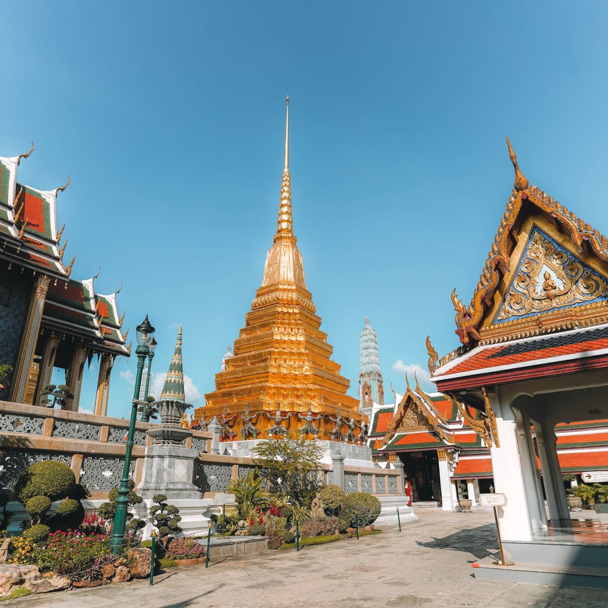 Golden pagoda and ornate Thai temple architecture at Wat Phra Kaeo, Bangkok.