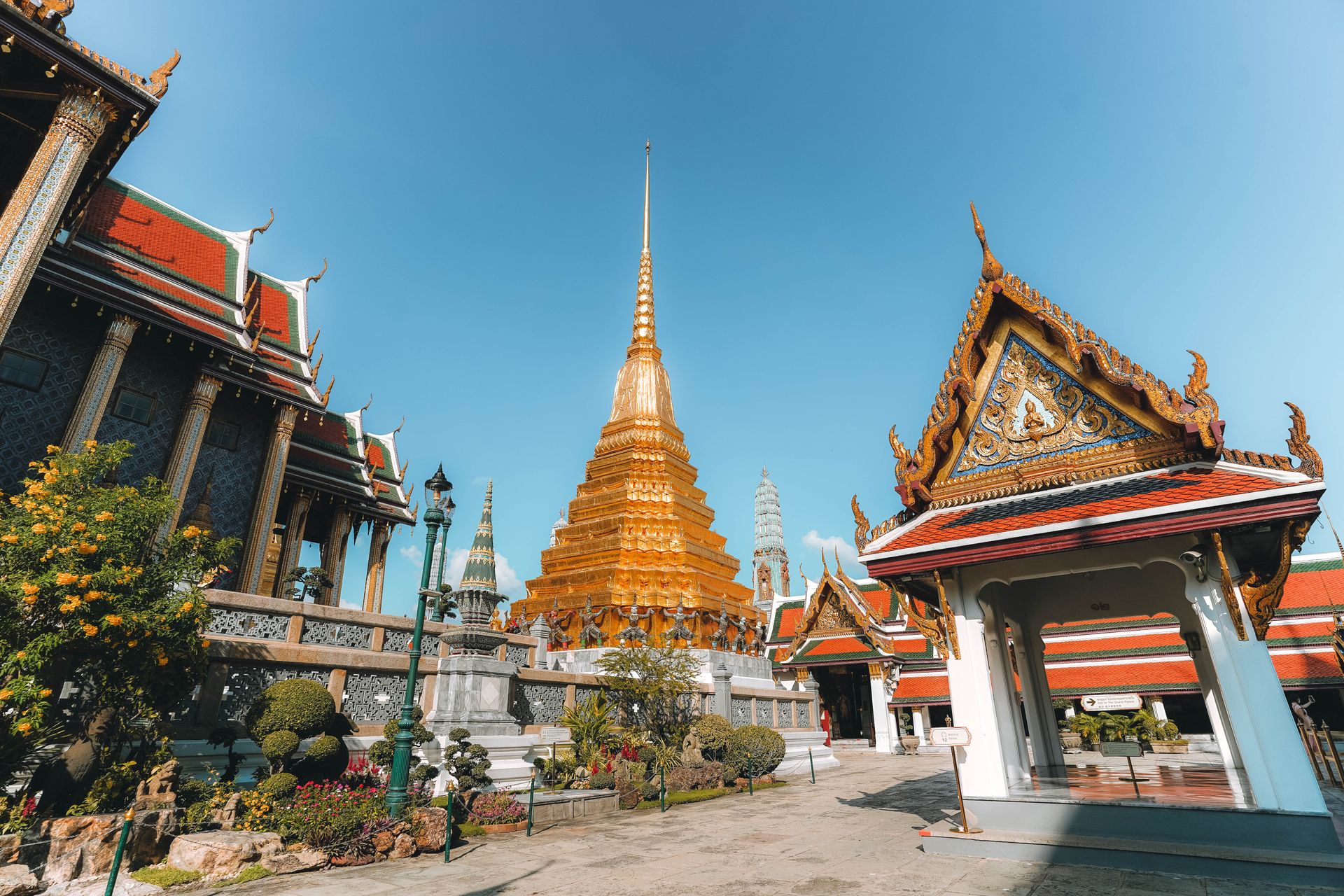 Golden pagoda and ornate Thai temple architecture at Wat Phra Kaeo, Bangkok.
