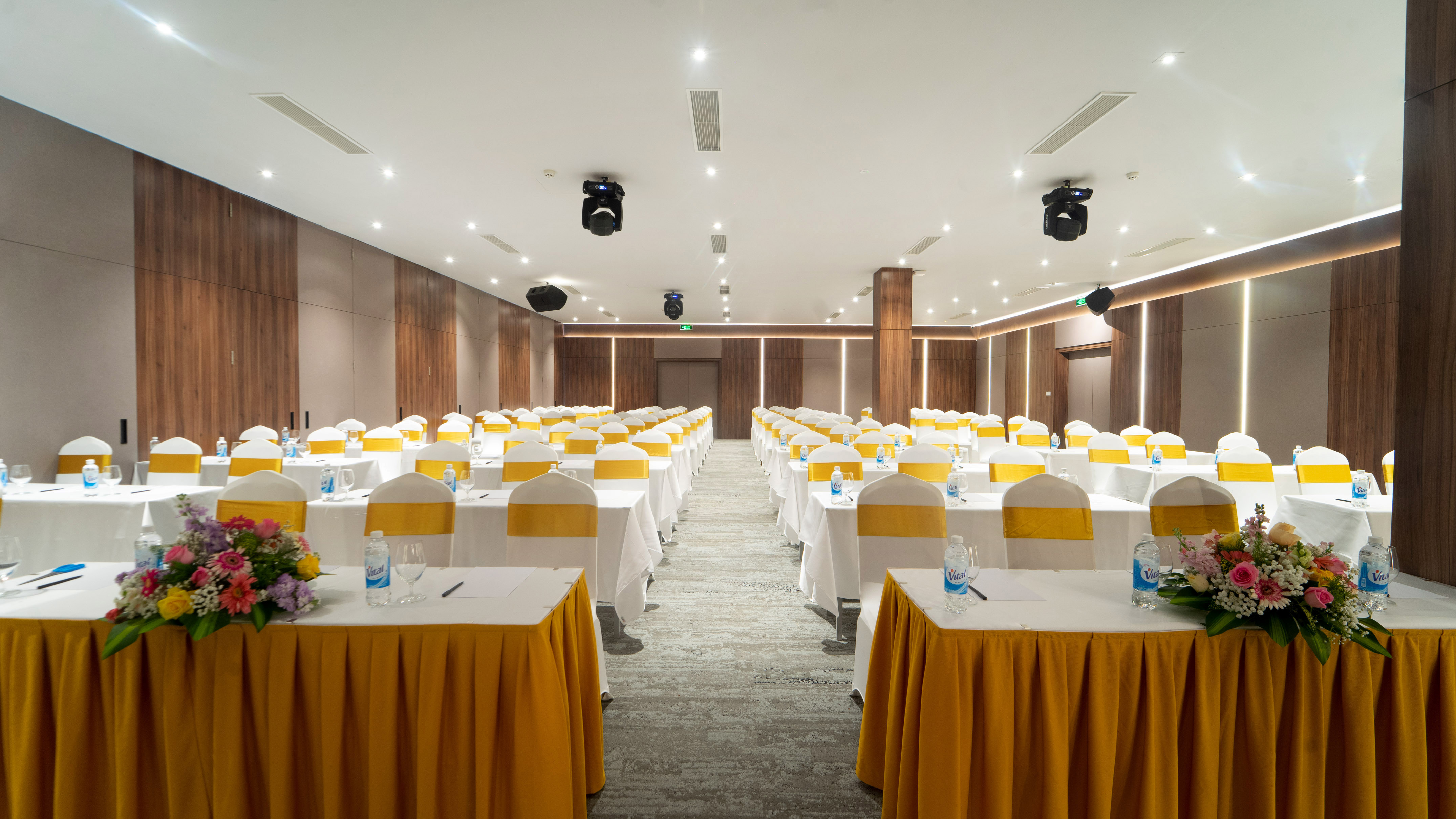 Empty modern conference room with yellow and white tables and chairs.