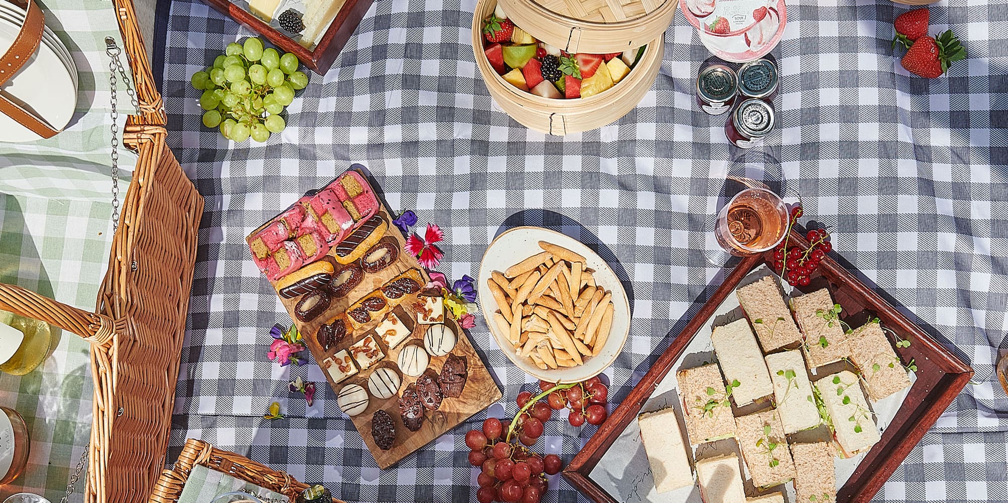 a picnic blanket with food and drinks