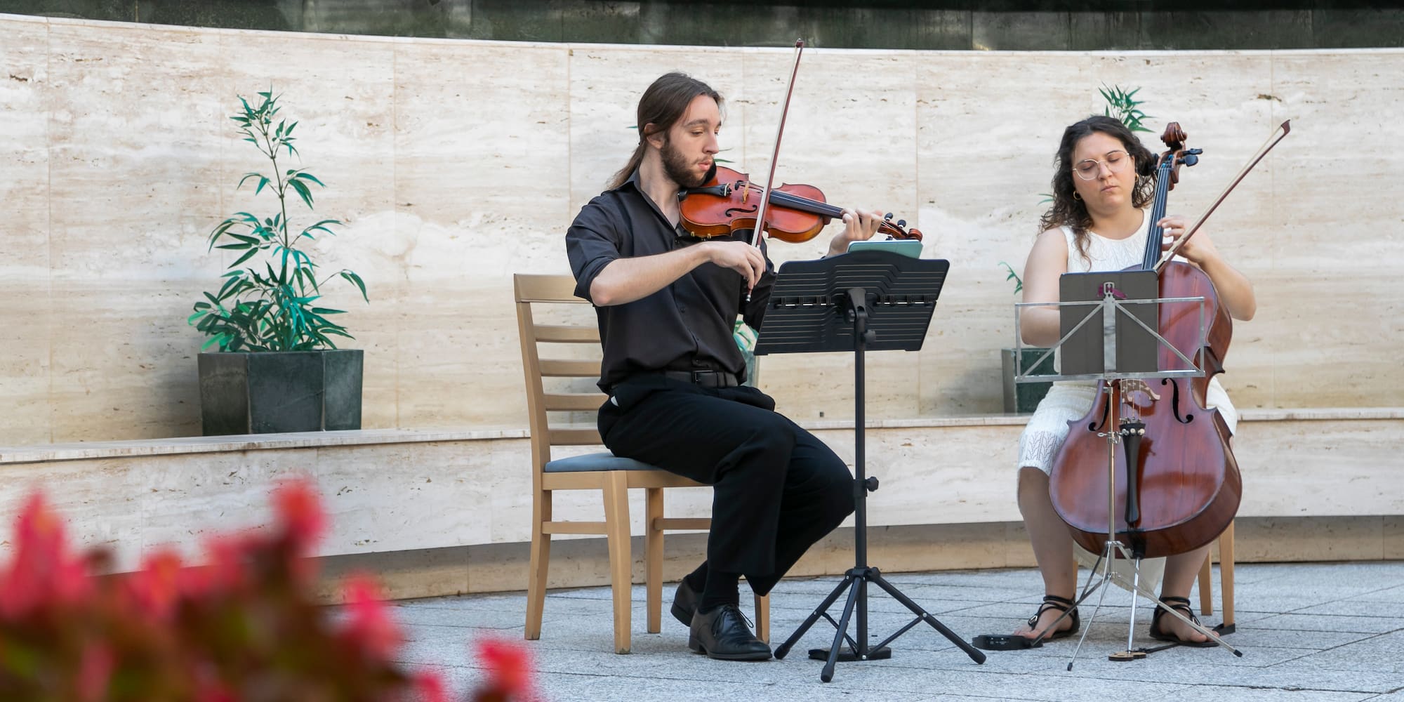 a man playing violin and a woman playing music