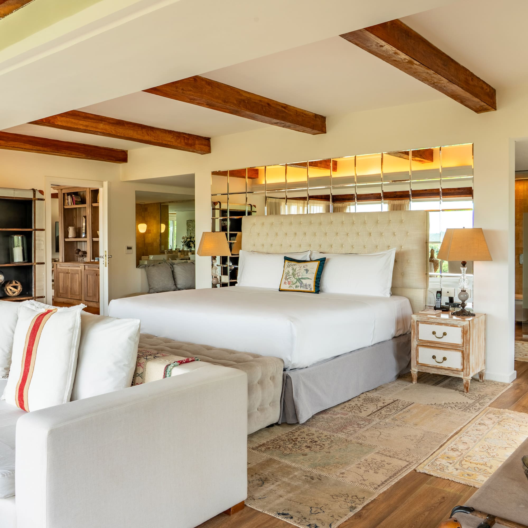 a bedroom with a large bed and a couch