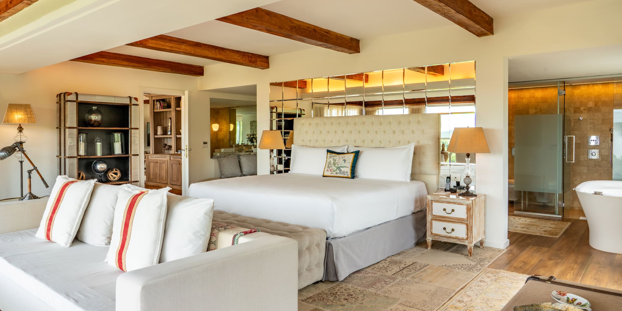 a bedroom with a large bed and a couch