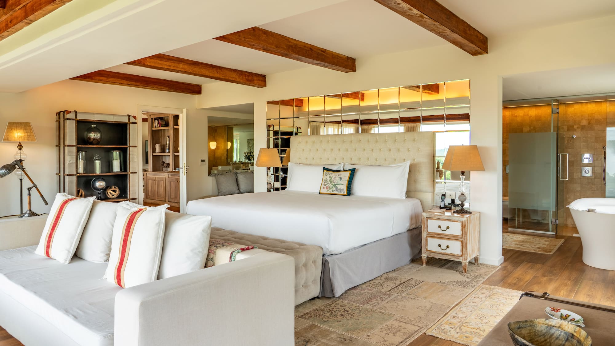 a bedroom with a large bed and a couch