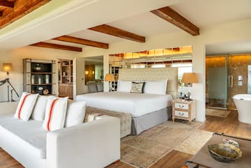 a bedroom with a large bed and a couch