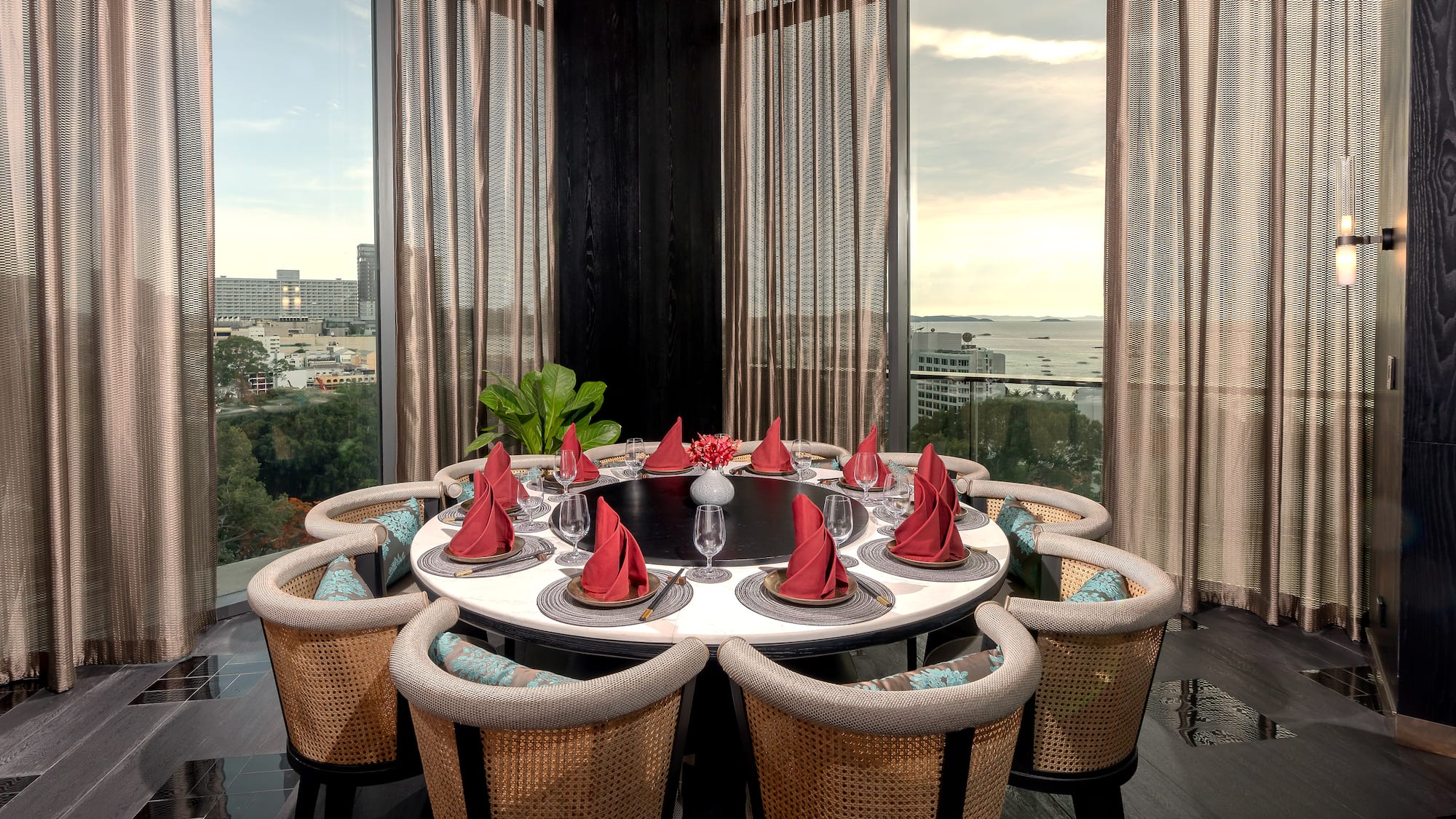 a table with red napkins and a flower shaped plate with red napkins