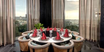 a table with red napkins and a flower shaped plate with red napkins