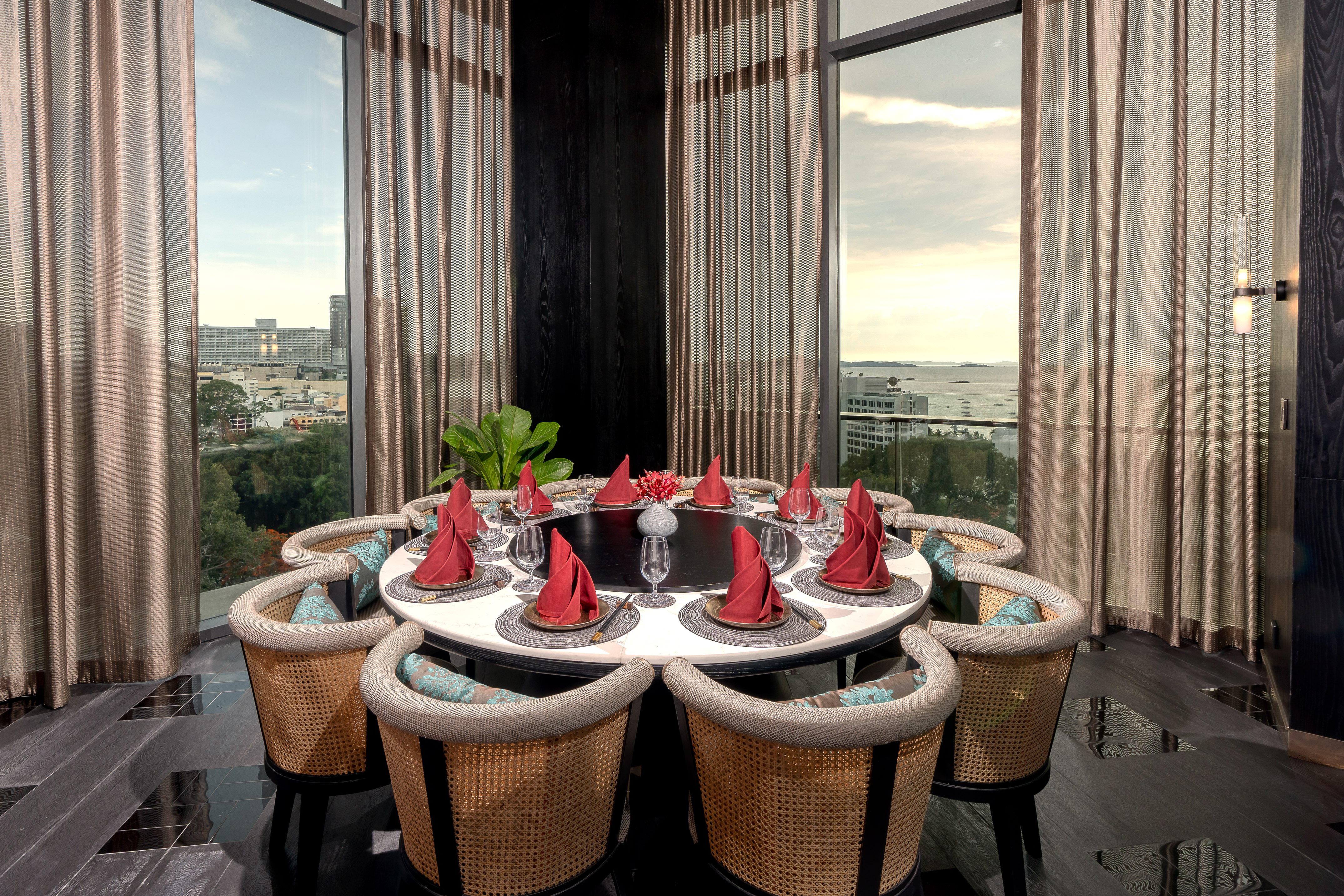 a table with red napkins and a flower shaped plate with red napkins