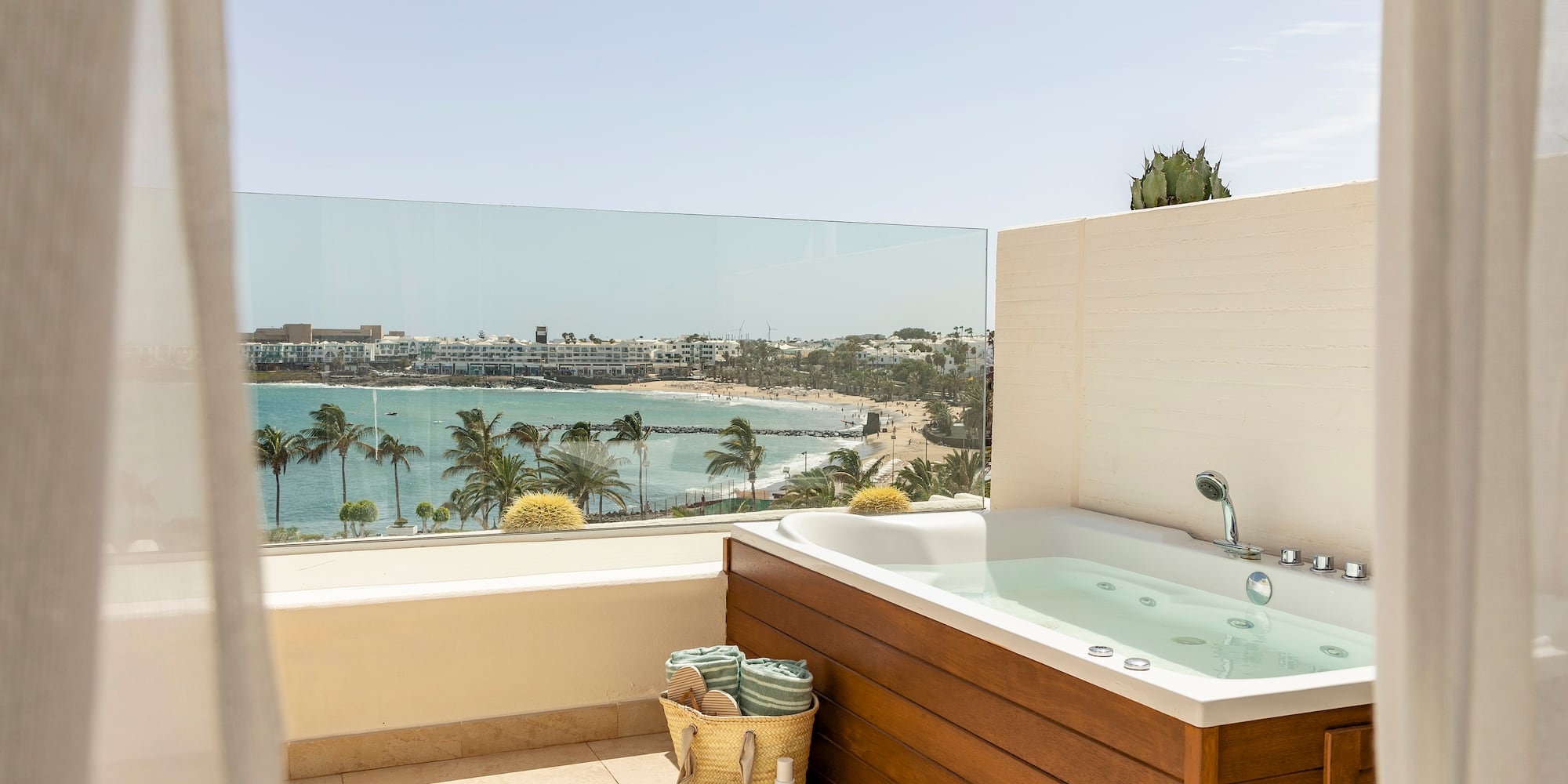 a bathtub on a balcony overlooking a body of water
