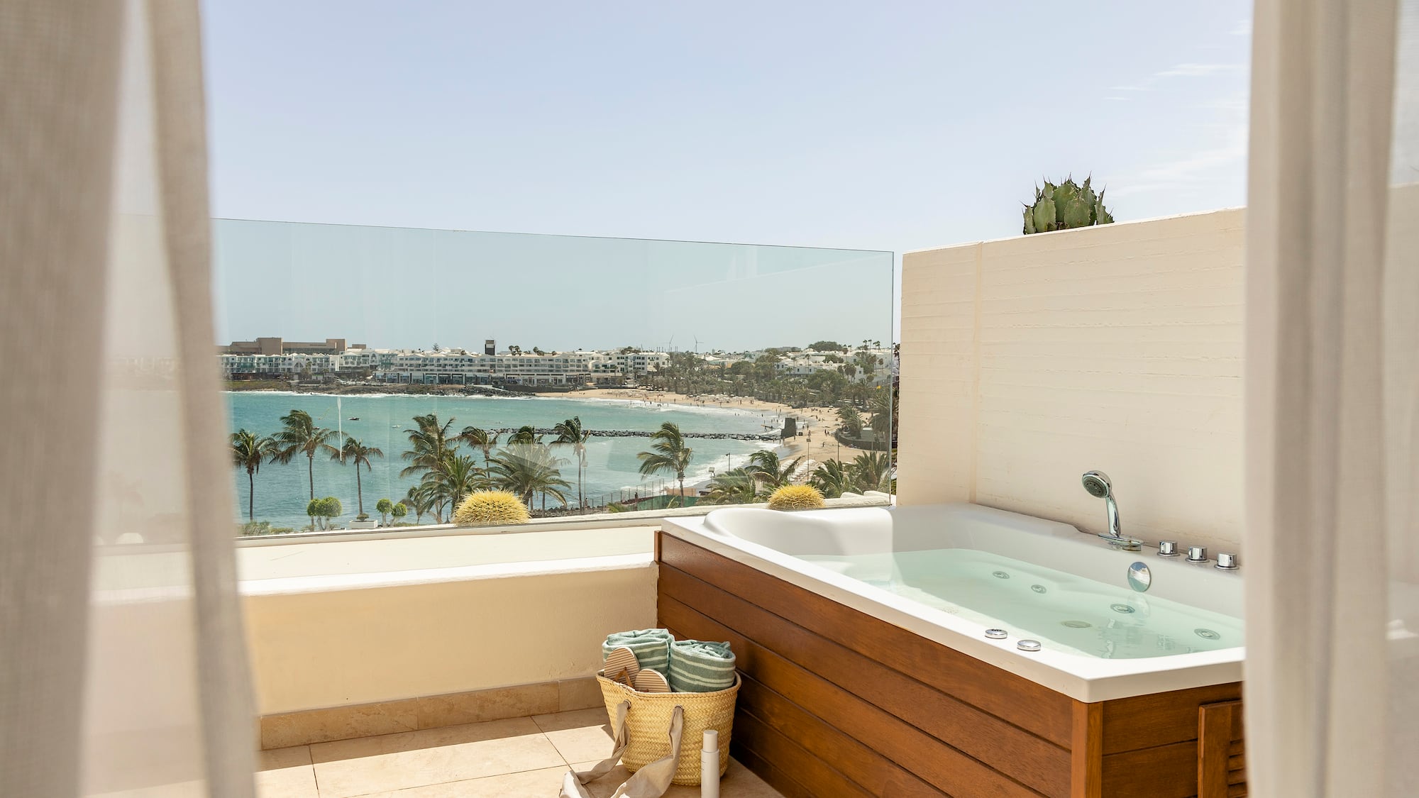 a bathtub on a balcony overlooking a body of water