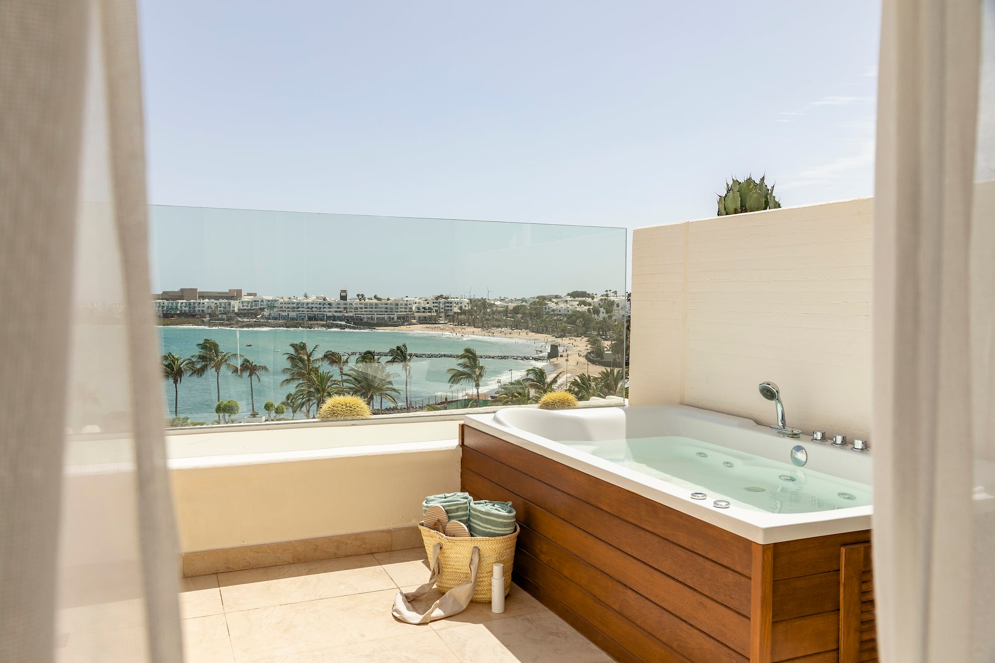 a bathtub on a balcony overlooking a body of water