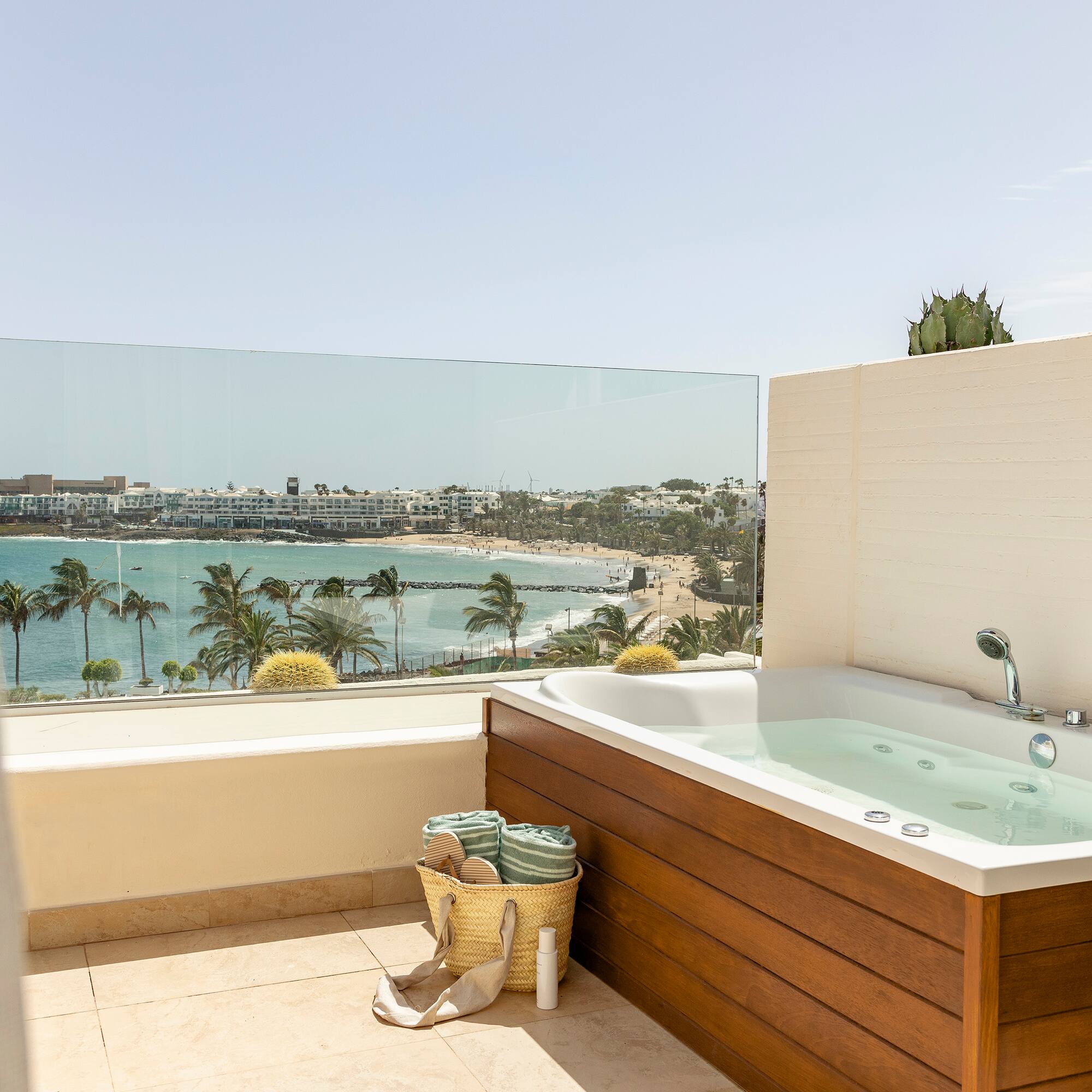 a bathtub on a balcony overlooking a body of water