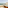 Balcony jacuzzi with sea view, sandy beach, palm trees, and resort.