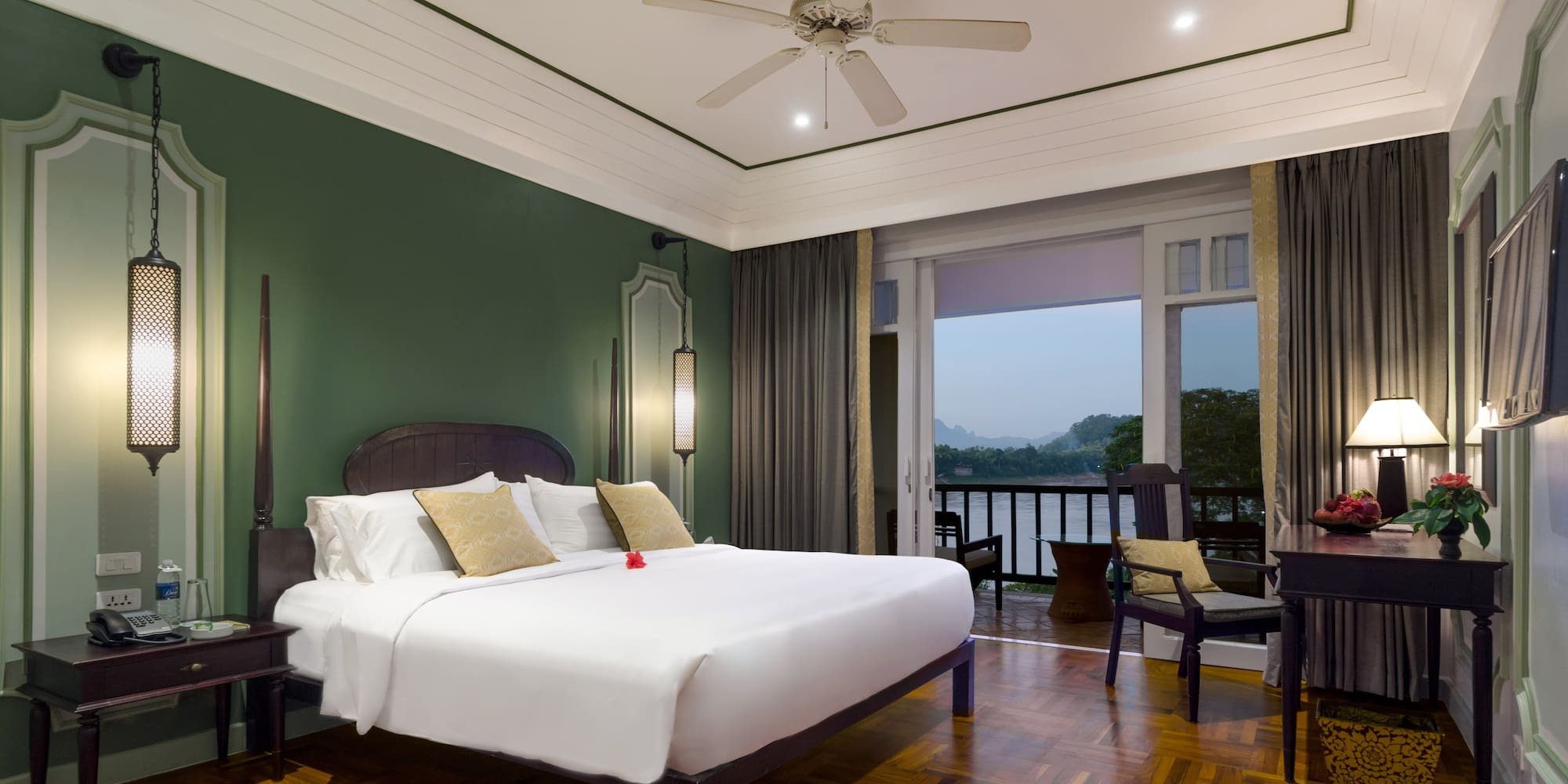 a room with a bed and a ceiling fan