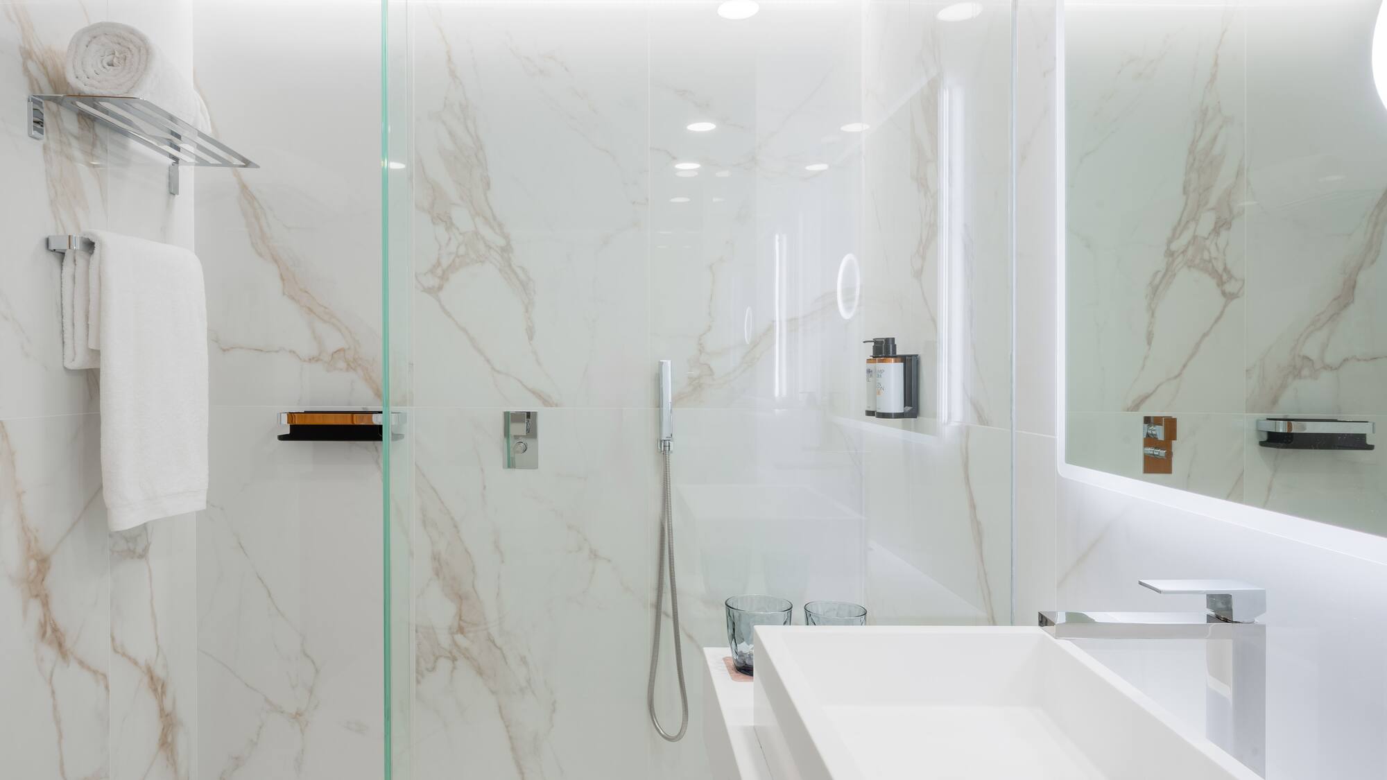 a bathroom with a glass shower and sink